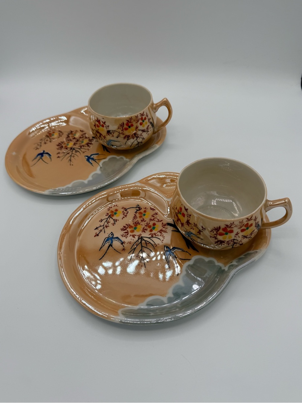 Pair of Japanese lusterware tea cups and integrated saucers-hand-painted